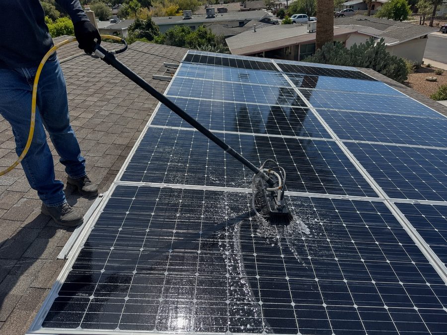 Cleaning solar panels on a roof